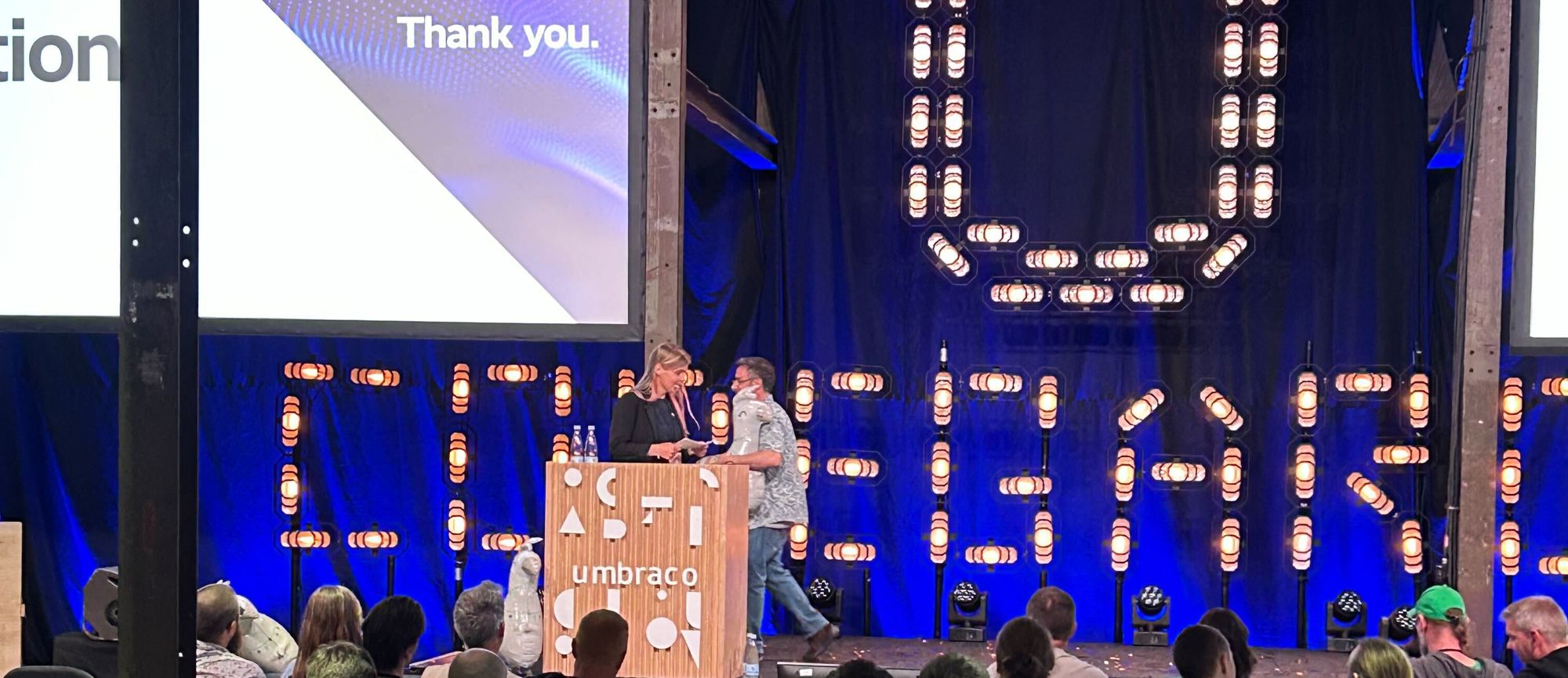 Vibrant stage at Codegarden event, set with professional lighting and presentation screens.